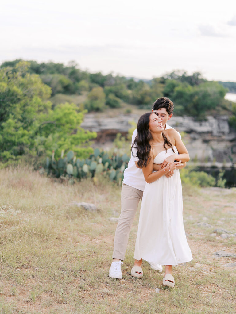Playful and candid Lake Travis proposal photography of newly engaged couple enjoying the moment together.