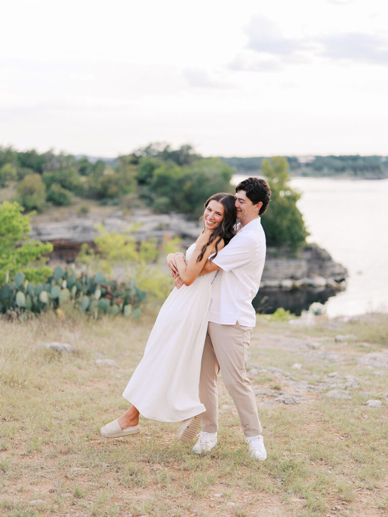 Playful and candid Lake Travis proposal photography of newly engaged couple enjoying the moment together.