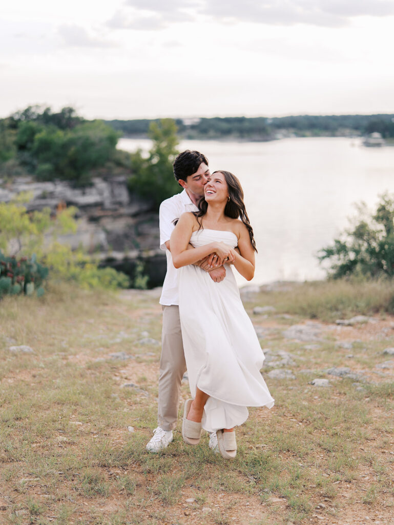 Playful and candid Lake Travis proposal photography of newly engaged couple enjoying the moment together.