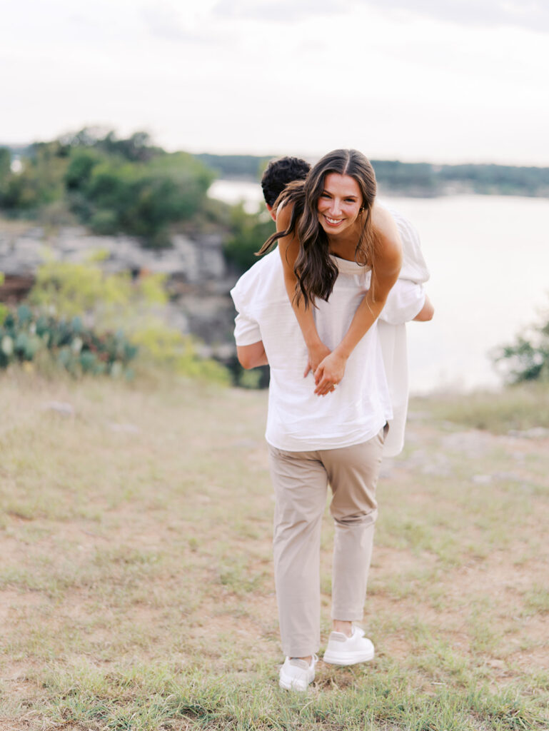 Playful and candid Lake Travis proposal photography of newly engaged couple enjoying the moment together.