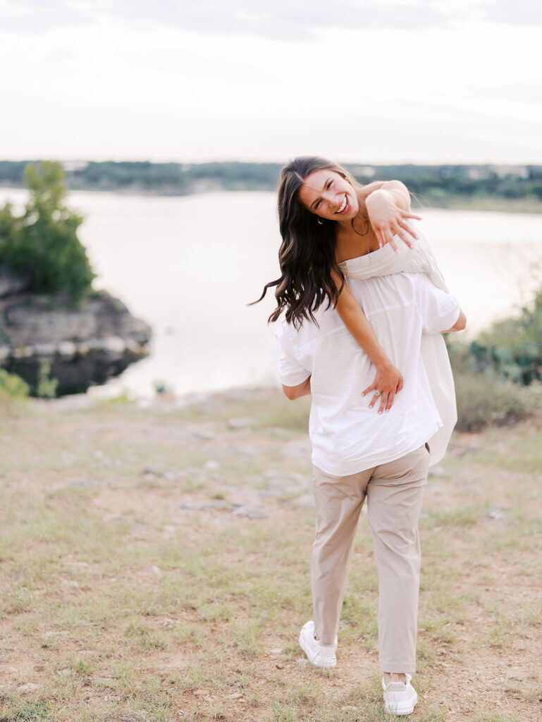 Playful and candid Lake Travis proposal photography of newly engaged couple enjoying the moment together.