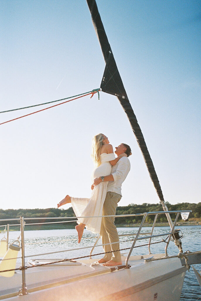 Romantic Lake Travis engagement photography with sailboat sunset views and playful, candid moments.