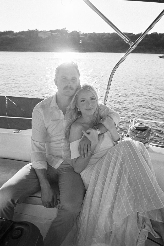 Romantic Lake Travis engagement photography with sailboat sunset views and playful, candid moments.