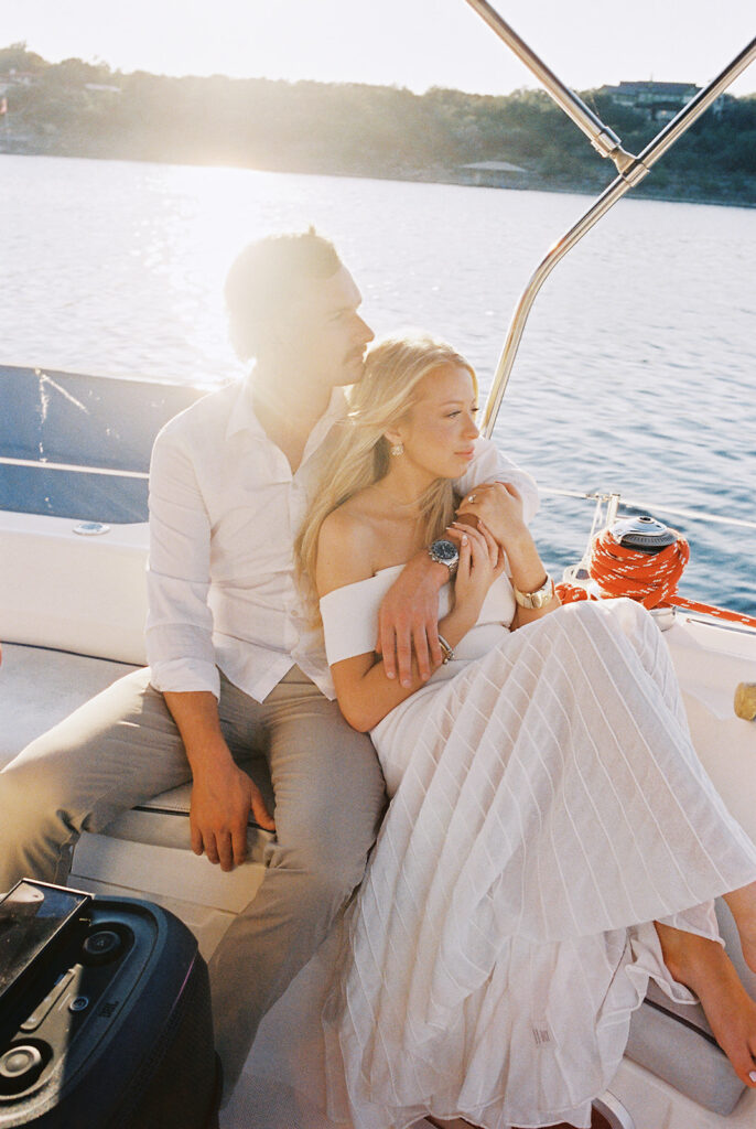 Romantic Lake Travis engagement photography with sailboat sunset views and playful, candid moments.