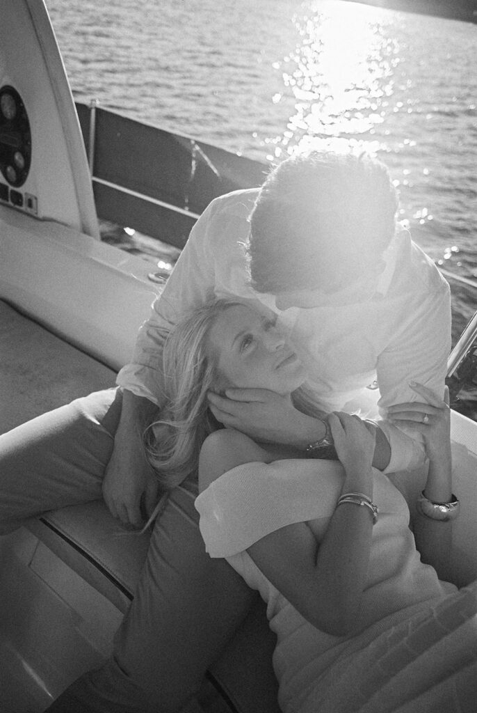 Romantic Lake Travis engagement photography with sailboat sunset views and playful, candid moments.