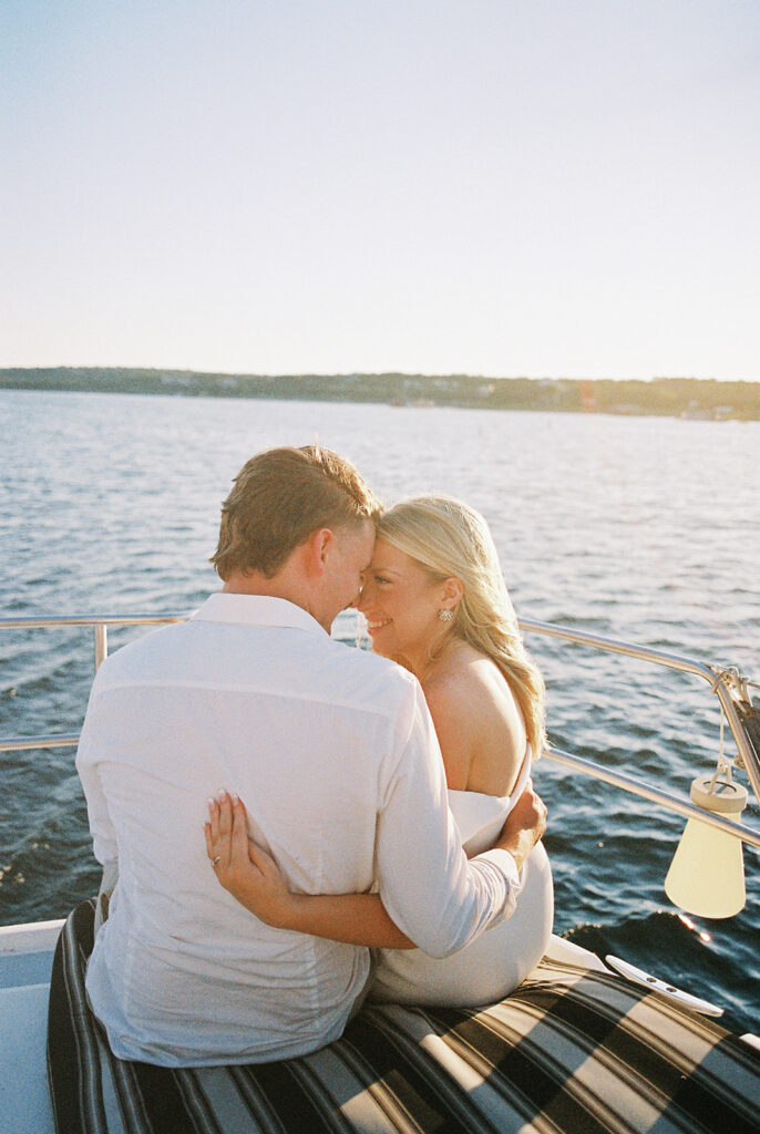 Romantic Lake Travis engagement photography with sailboat sunset views and playful, candid moments.