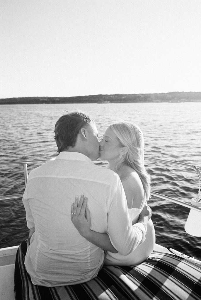 Romantic Lake Travis engagement photography with sailboat sunset views and playful, candid moments.