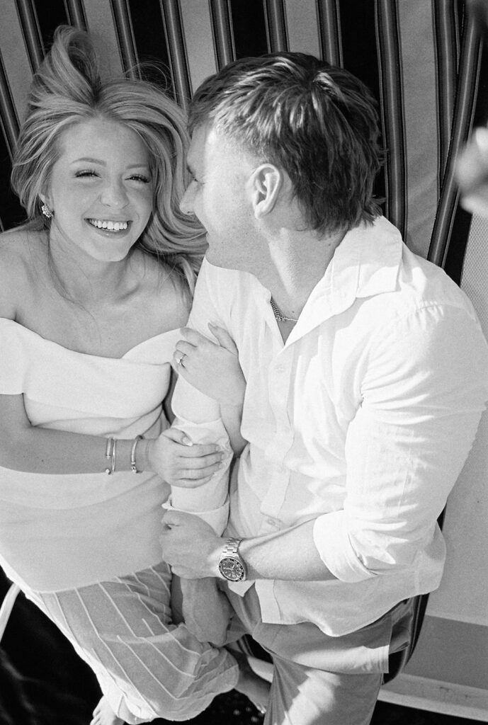Romantic Lake Travis engagement photography with sailboat sunset views and playful, candid moments.