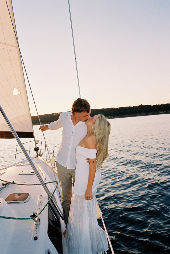 Romantic Lake Travis engagement photography with sailboat sunset views and playful, candid moments.