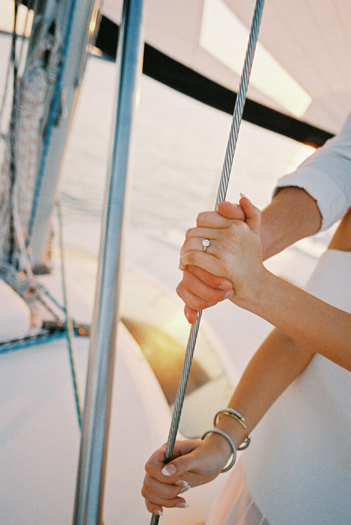 Romantic Lake Travis engagement photography with sailboat sunset views and playful, candid moments.