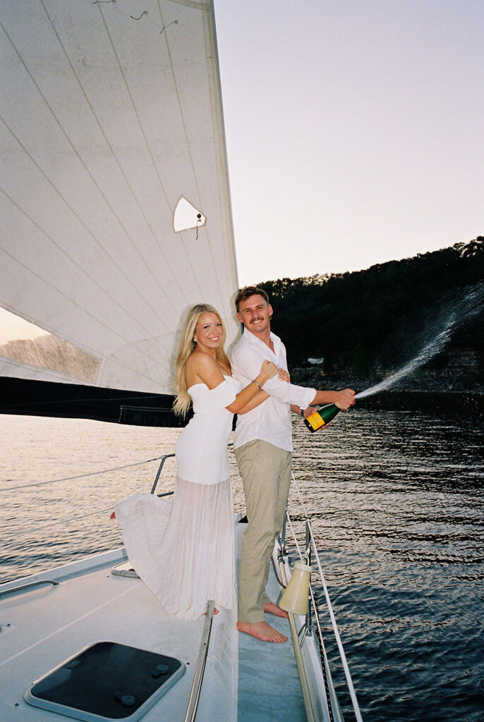 Romantic Lake Travis engagement photography with sailboat sunset views and playful, candid moments.