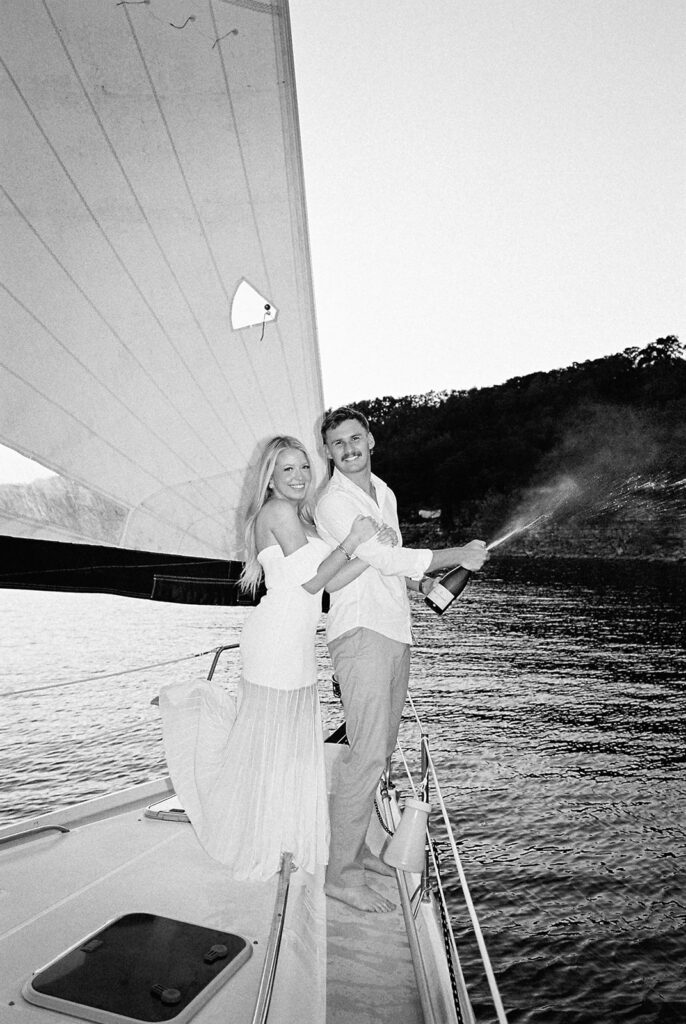 Romantic Lake Travis engagement photography with sailboat sunset views and playful, candid moments.