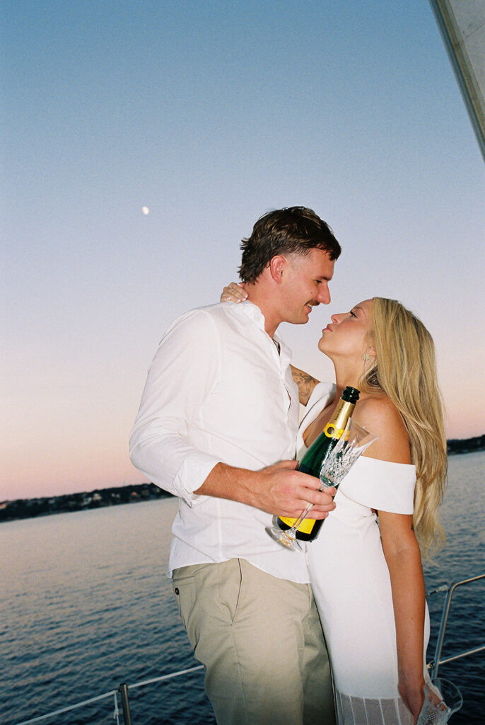 Romantic Lake Travis engagement photography with sailboat sunset views and playful, candid moments.