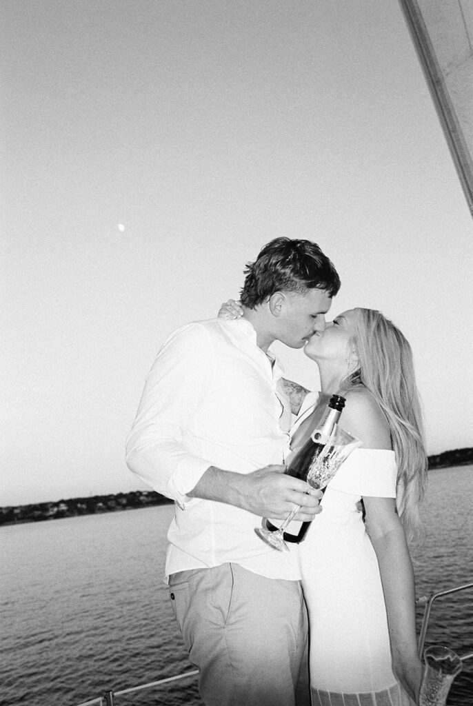 Romantic Lake Travis engagement photography with sailboat sunset views and playful, candid moments.