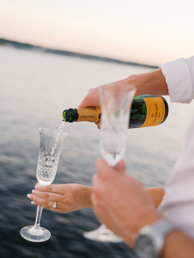 Ainslea and Carson’s Lake Travis sailboat engagement photos in glowing golden hour light, romantic and timeless.