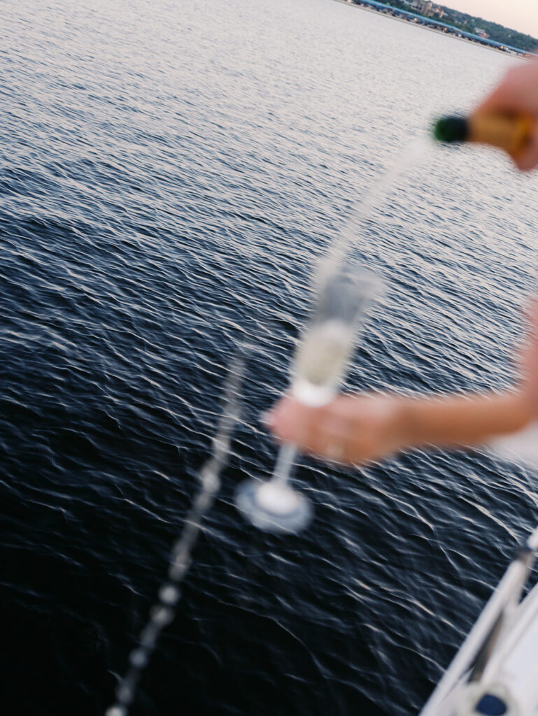 Ainslea and Carson’s Lake Travis sailboat engagement photos in glowing golden hour light, romantic and timeless.