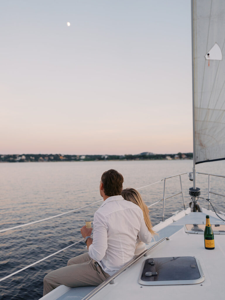 Ainslea and Carson’s Lake Travis sailboat engagement photos in glowing golden hour light, romantic and timeless.