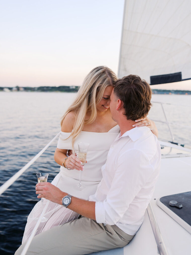 Ainslea and Carson’s Lake Travis sailboat engagement photos in glowing golden hour light, romantic and timeless.