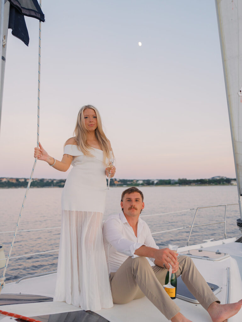 Ainslea and Carson’s Lake Travis sailboat engagement photos in glowing golden hour light, romantic and timeless.