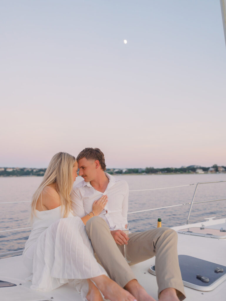 Ainslea and Carson’s Lake Travis sailboat engagement photos in glowing golden hour light, romantic and timeless.
