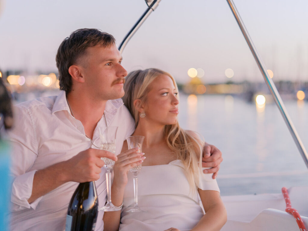 Ainslea and Carson’s Lake Travis sailboat engagement photos in glowing golden hour light, romantic and timeless.