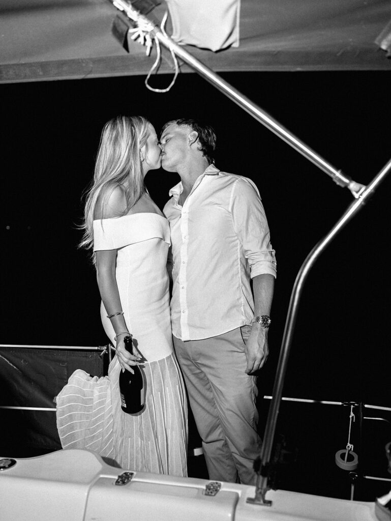 Playful Lake Travis sailboat engagement photos as the couple jumps off the boat for a spontaneous swim.