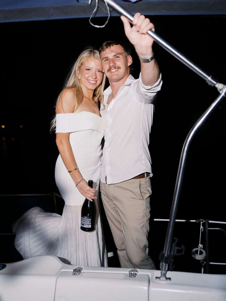 Playful Lake Travis sailboat engagement photos as the couple jumps off the boat for a spontaneous swim.