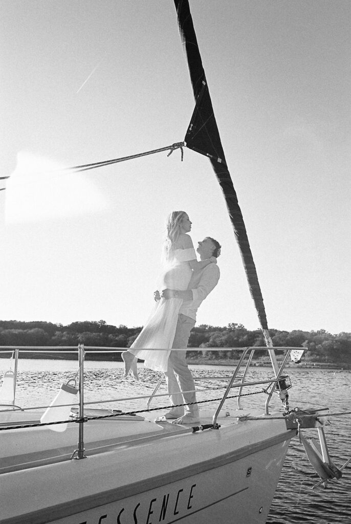 Romantic Lake Travis engagement photography with sailboat sunset views and playful, candid moments.