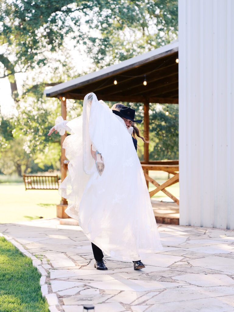 Bride and groom at The Adelphia wedding editorial in Lampasas, TX, surrounded by romantic florals and southern charm