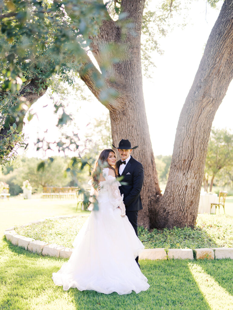 Bride and groom at The Adelphia wedding editorial in Lampasas, TX, surrounded by romantic florals and southern charm.