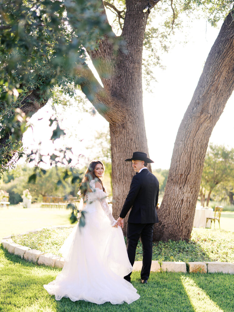Bride and groom at The Adelphia wedding editorial in Lampasas, TX, surrounded by romantic florals and southern charm.