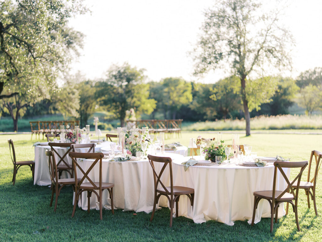 Romantic southern wedding tablescape at The Adelphia with lush florals, soft candlelight, and elegant rentals styled by Simply Bliss Events