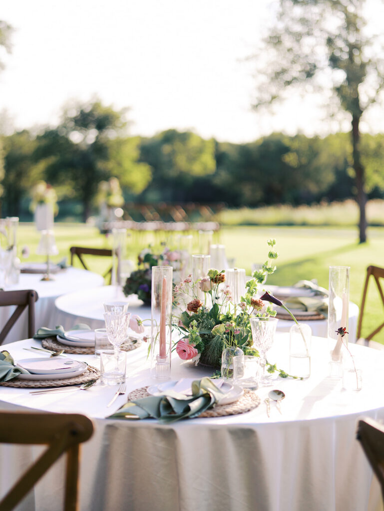 Romantic southern wedding tablescape at The Adelphia with lush florals, soft candlelight, and elegant rentals styled by Simply Bliss Events