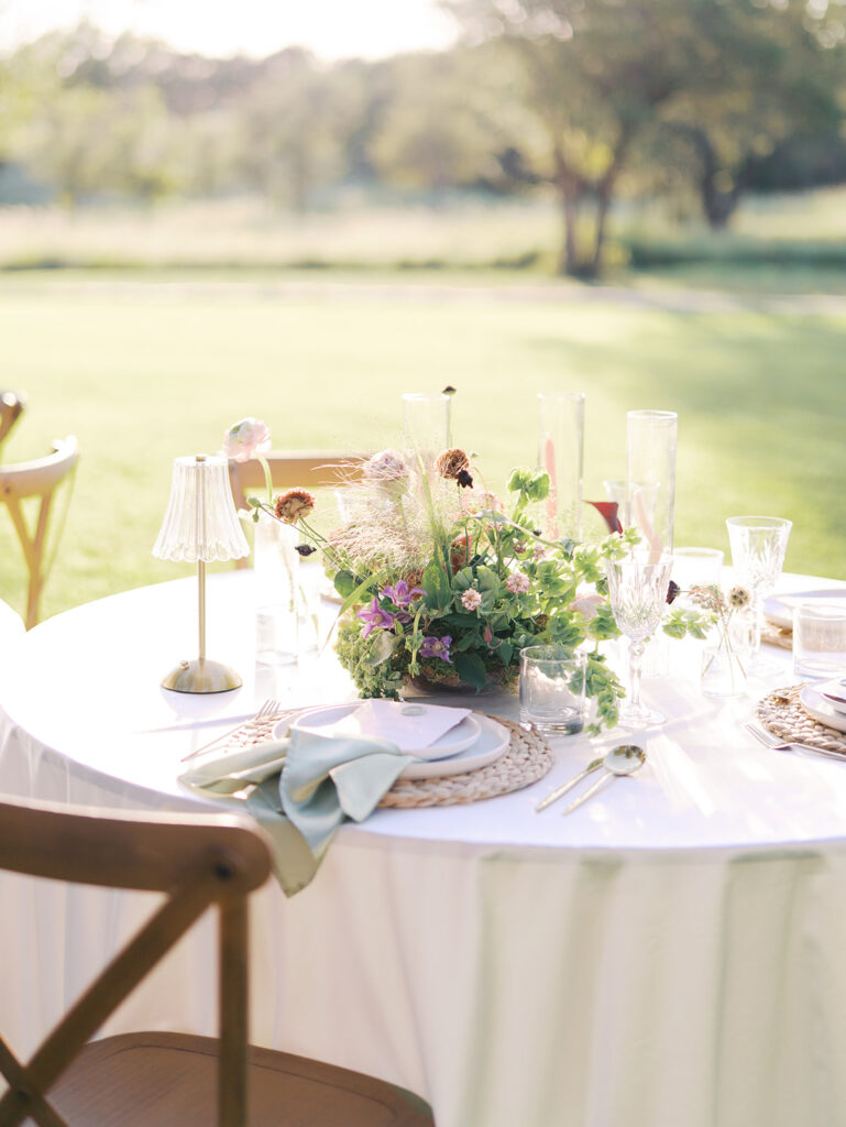 Romantic southern wedding tablescape at The Adelphia with lush florals, soft candlelight, and elegant rentals styled by Simply Bliss Events