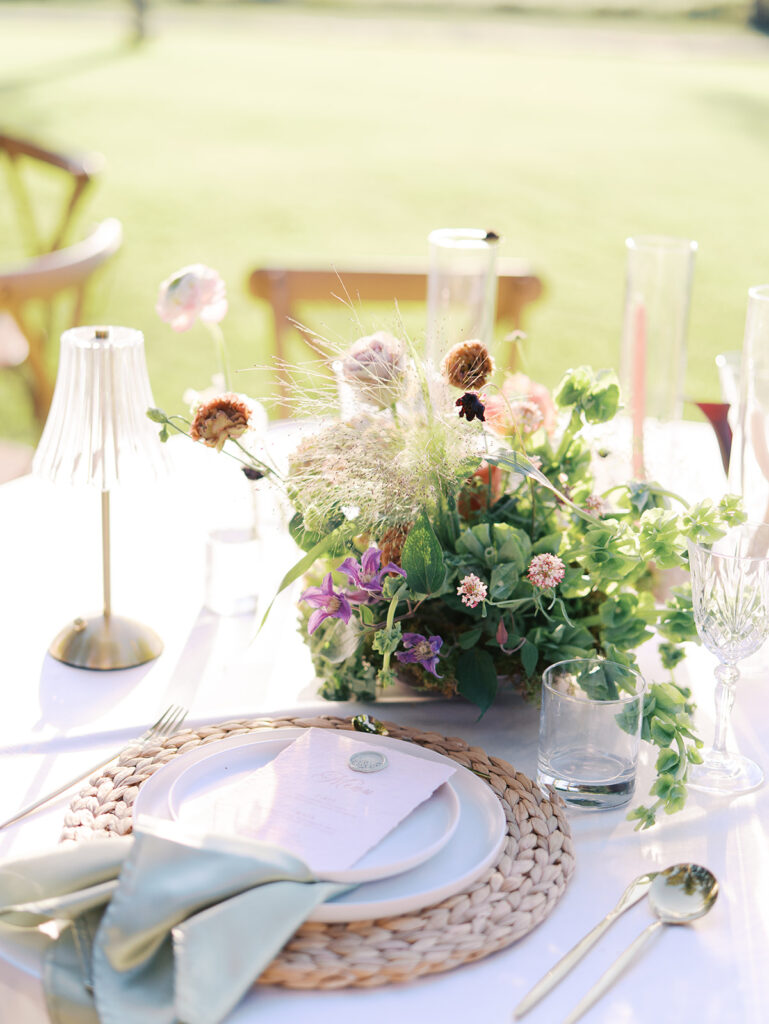 Romantic southern wedding tablescape at The Adelphia with lush florals, soft candlelight, and elegant rentals styled by Simply Bliss Events