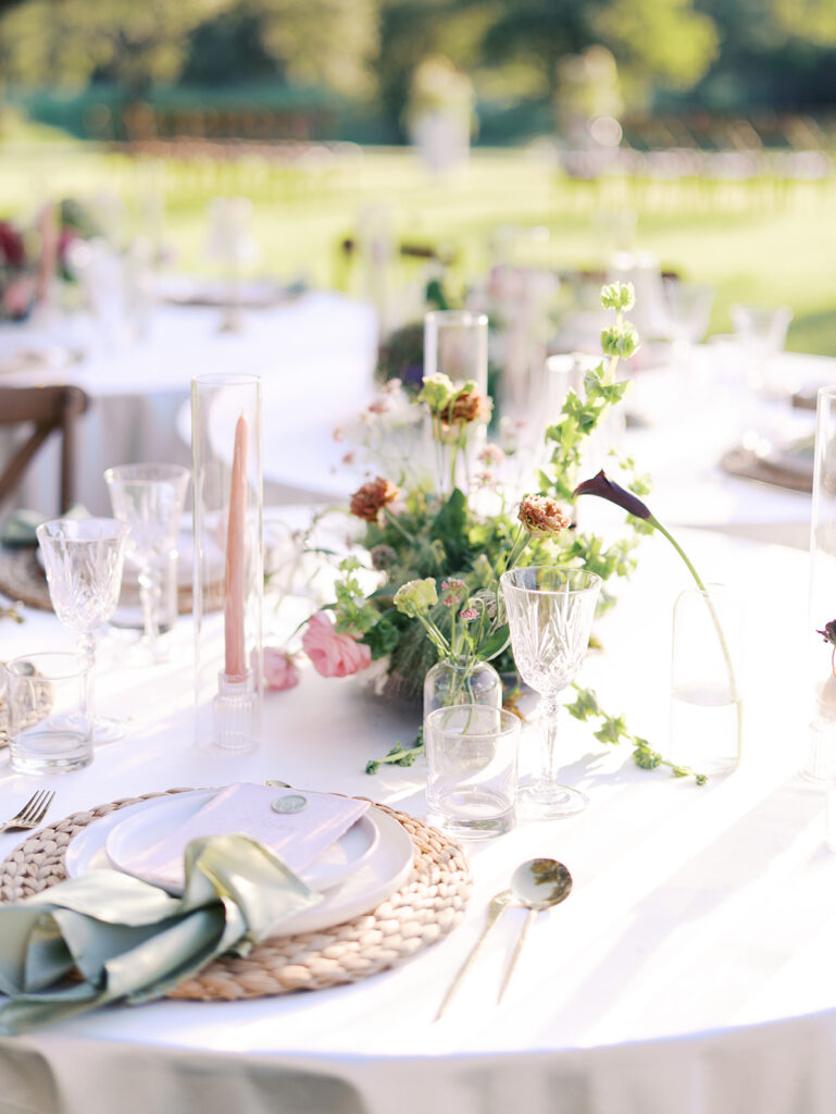 Romantic southern wedding tablescape at The Adelphia with lush florals, soft candlelight, and elegant rentals styled by Simply Bliss Events