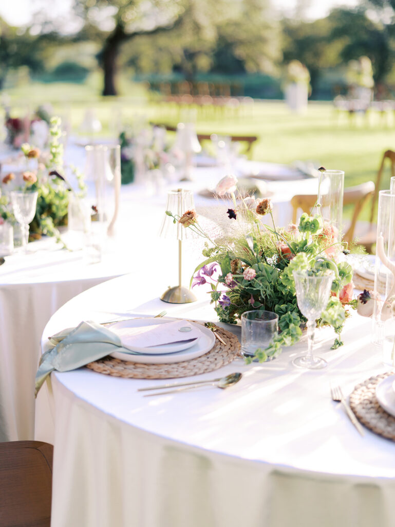 Romantic southern wedding tablescape at The Adelphia with lush florals, soft candlelight, and elegant rentals styled by Simply Bliss Events