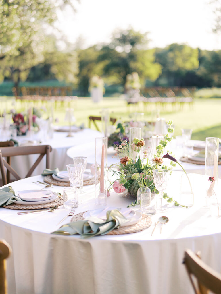 Romantic southern wedding tablescape at The Adelphia with lush florals, soft candlelight, and elegant rentals styled by Simply Bliss Events