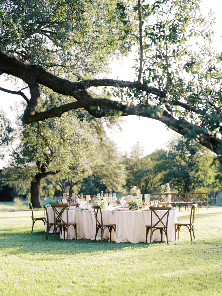 Romantic southern wedding tablescape at The Adelphia with lush florals, soft candlelight, and elegant rentals styled by Simply Bliss Events