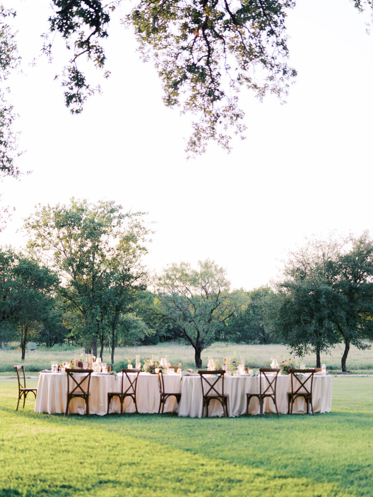 Romantic southern wedding tablescape at The Adelphia with lush florals, soft candlelight, and elegant rentals styled by Simply Bliss Events