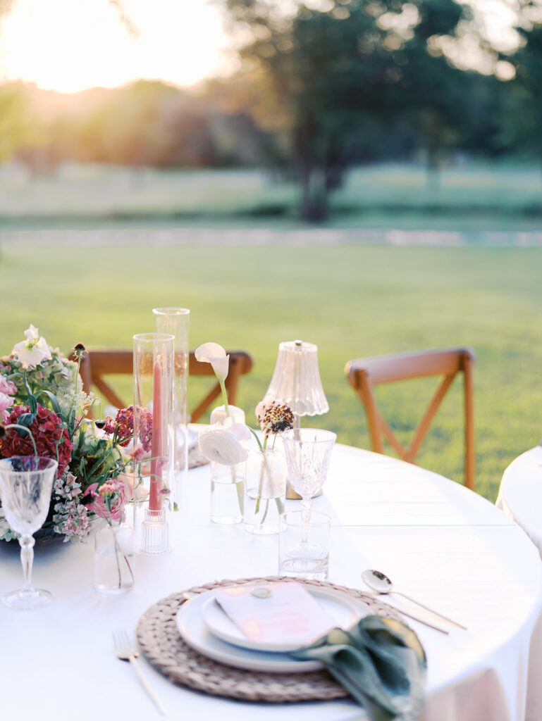 Romantic southern wedding tablescape at The Adelphia with lush florals, soft candlelight, and elegant rentals styled by Simply Bliss Events