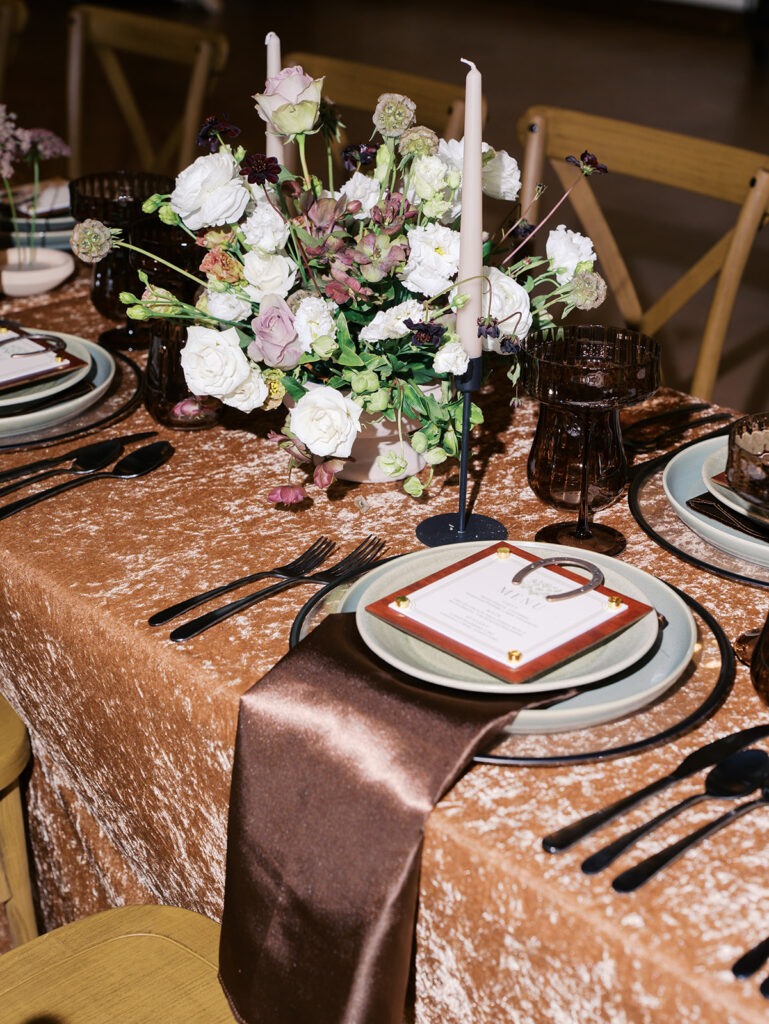 romantic southern wedding tablescape at The Adelphia with lush florals, soft candlelight, and elegant rentals styled by Simply Bliss Events.