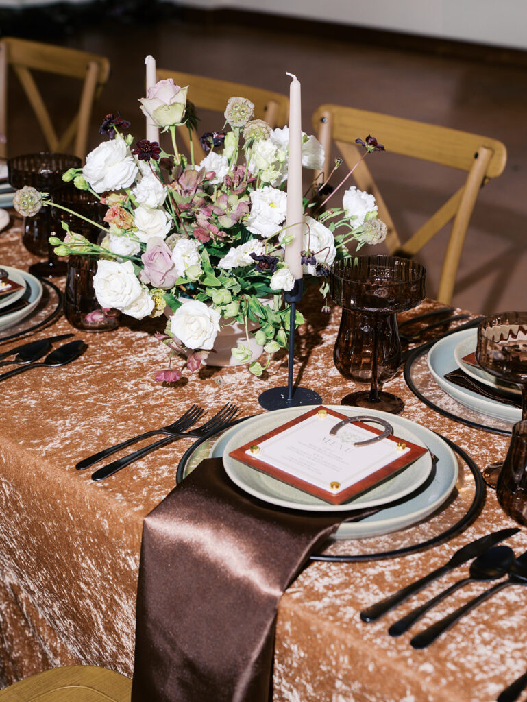 Romantic southern wedding tablescape at The Adelphia with lush florals, soft candlelight, and elegant rentals styled by Simply Bliss Events
