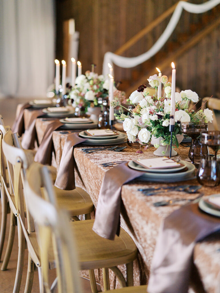Romantic southern wedding tablescape at The Adelphia with lush florals, soft candlelight, and elegant rentals styled by Simply Bliss Events