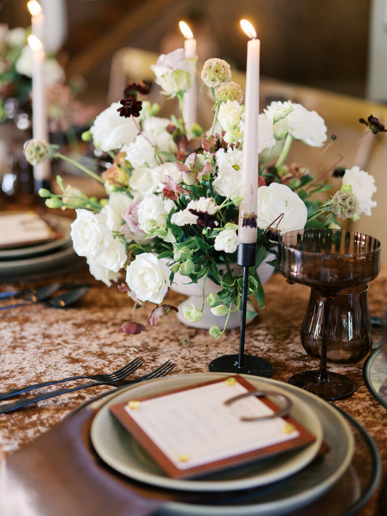 Romantic southern wedding tablescape at The Adelphia with lush florals, soft candlelight, and elegant rentals styled by Simply Bliss Events