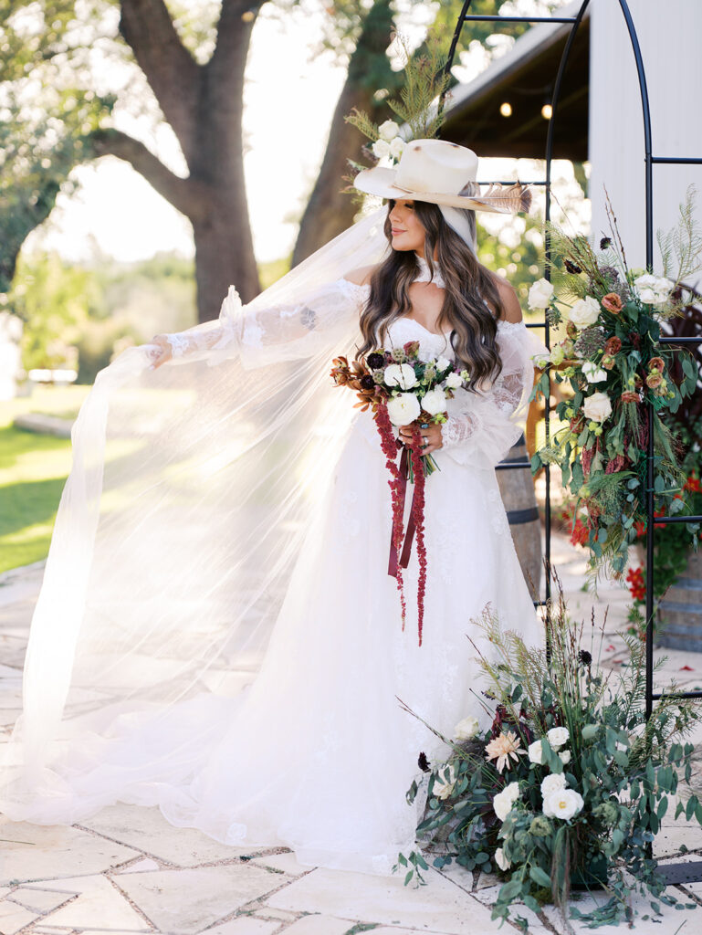 Bride and groom embracing at The Adelphia during a romantic southern wedding editorial, surrounded by lush florals and timeless charm