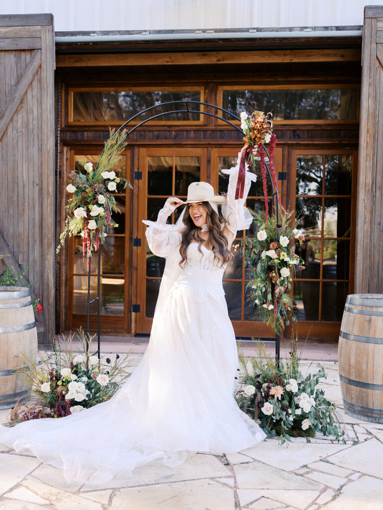 Bride and groom embracing at The Adelphia during a romantic southern wedding editorial, surrounded by lush florals and timeless charm