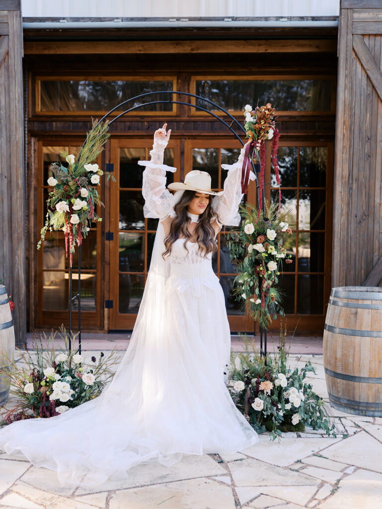 Bride and groom embracing at The Adelphia during a romantic southern wedding editorial, surrounded by lush florals and timeless charm