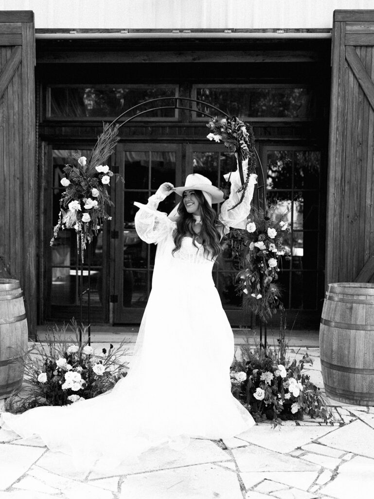 Bride and groom embracing at The Adelphia during a romantic southern wedding editorial, surrounded by lush florals and timeless charm