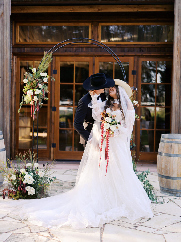 Bride and groom embracing at The Adelphia during a romantic southern wedding editorial, surrounded by lush florals and timeless charm